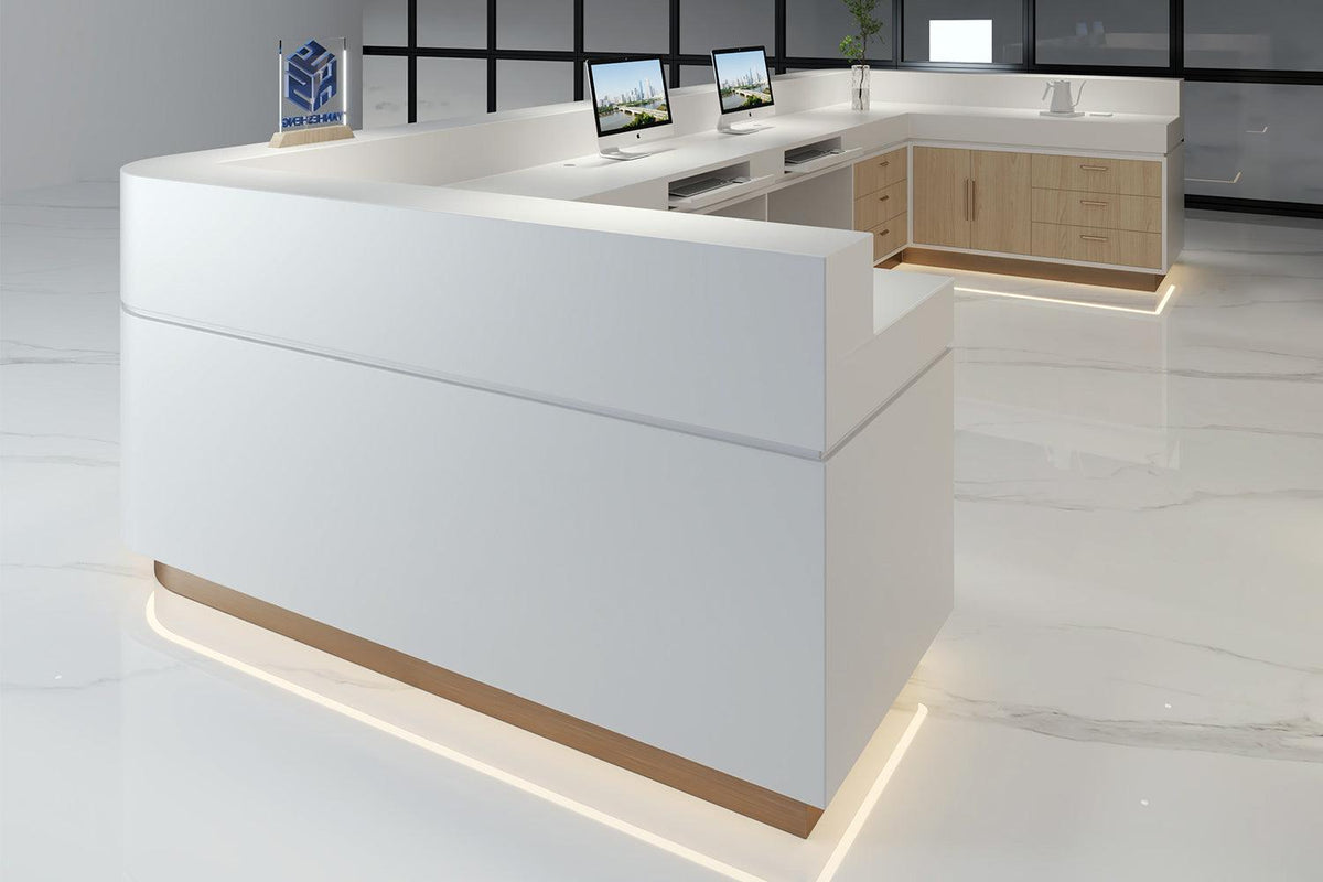 Side view of modern white solid surface reception desk for beauty and office spaces with seamless acrylic solid surface finish