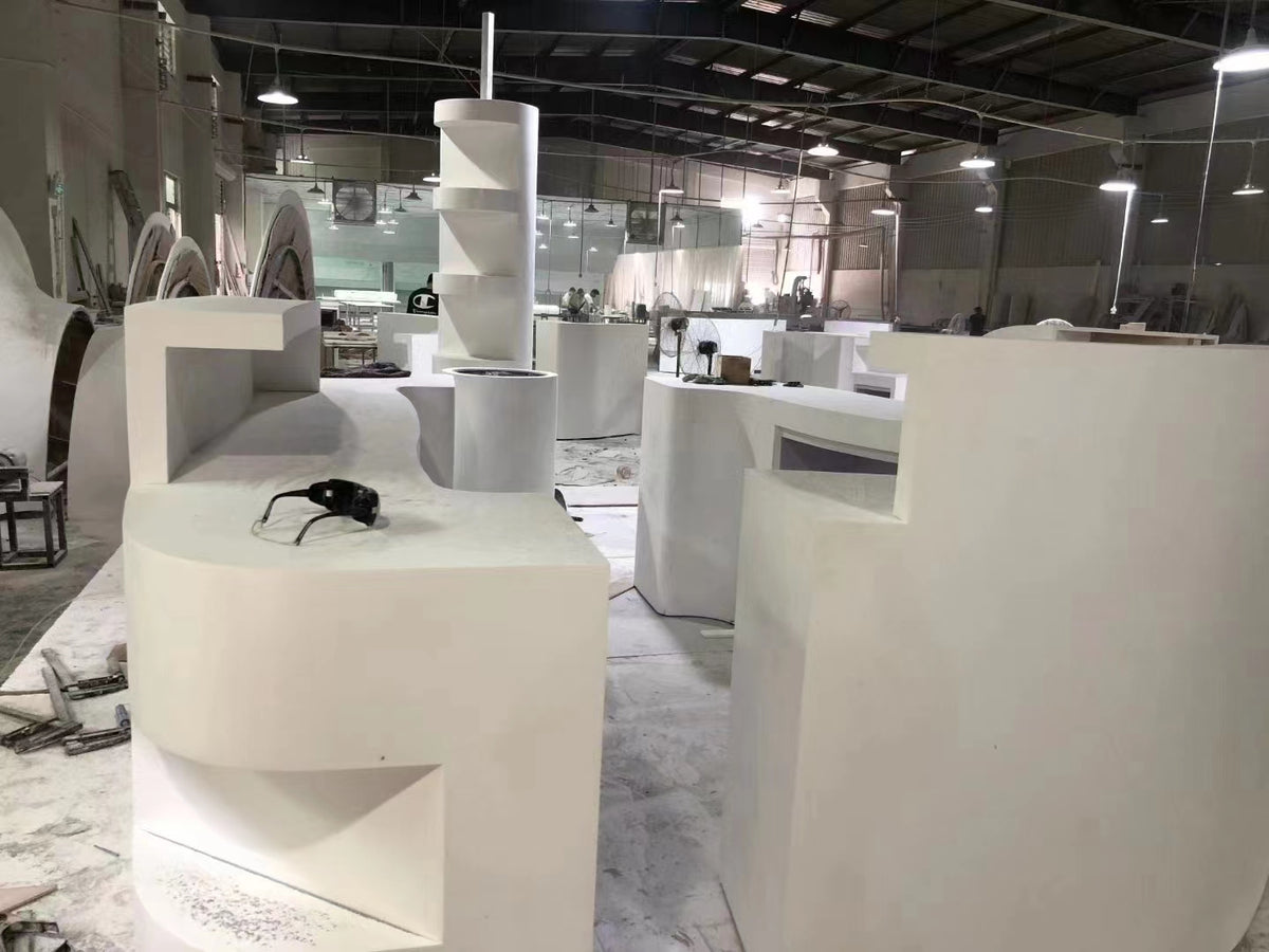 Custom solid surface furniture components being assembled in a production workshop
