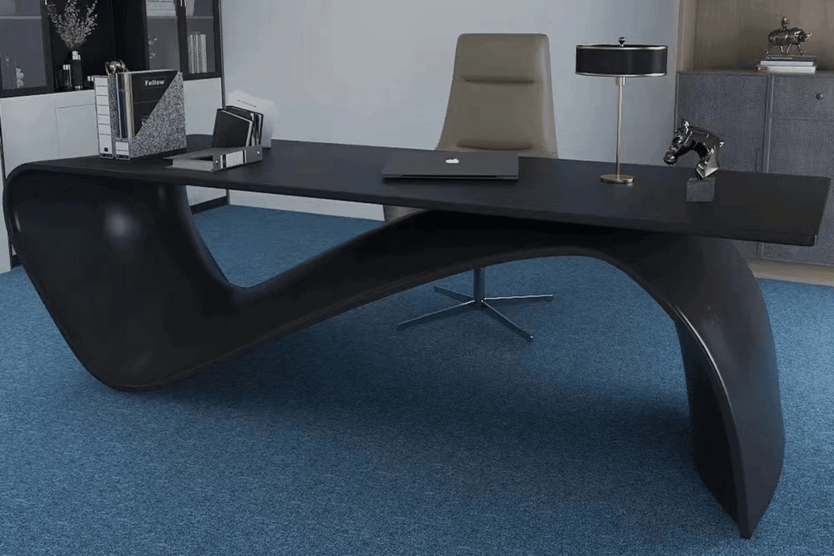 Side view of black shaped solid surface manager table for executive offices with seamless acrylic solid surface finish