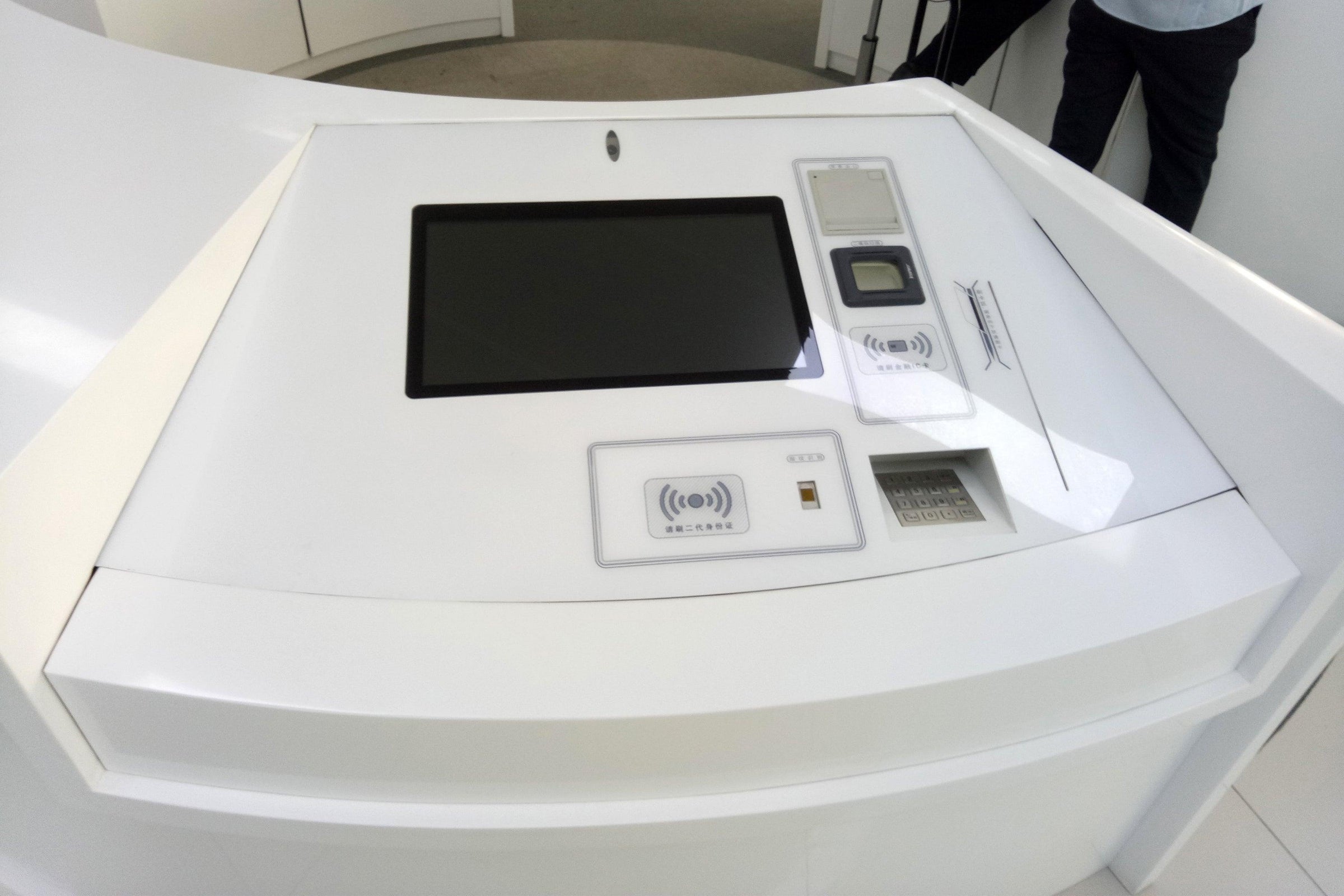 Side view of custom solid surface airport check-in counter with kiosk integration with seamless acrylic solid surface finish