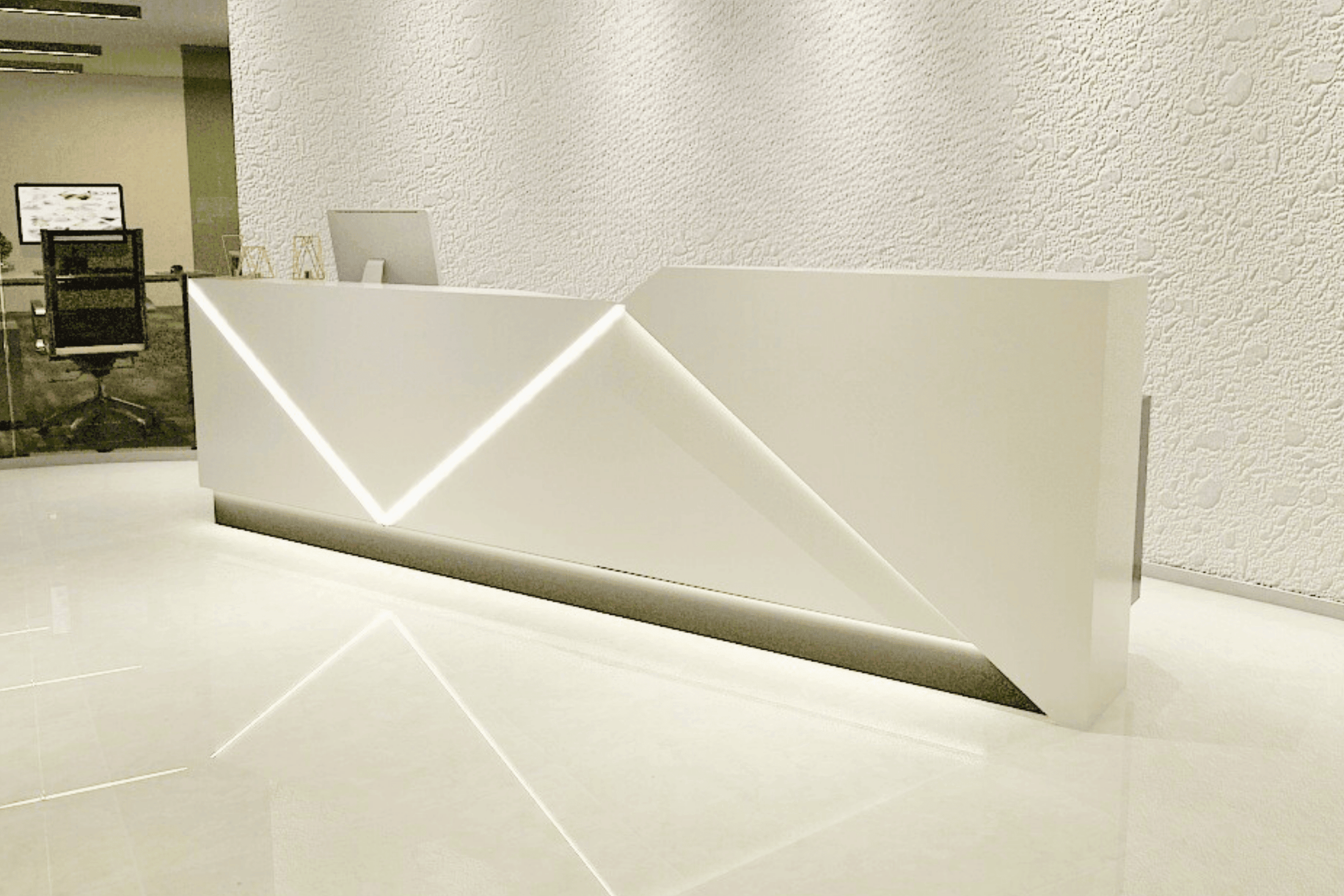 Side view of led solid surface reception desk for premium company lobbies with seamless acrylic solid surface finish
