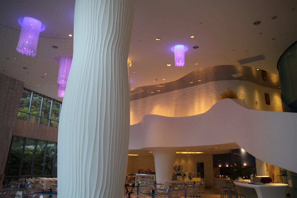 Side view of white solid surface decorative columns for commercial interiors with seamless acrylic solid surface finish