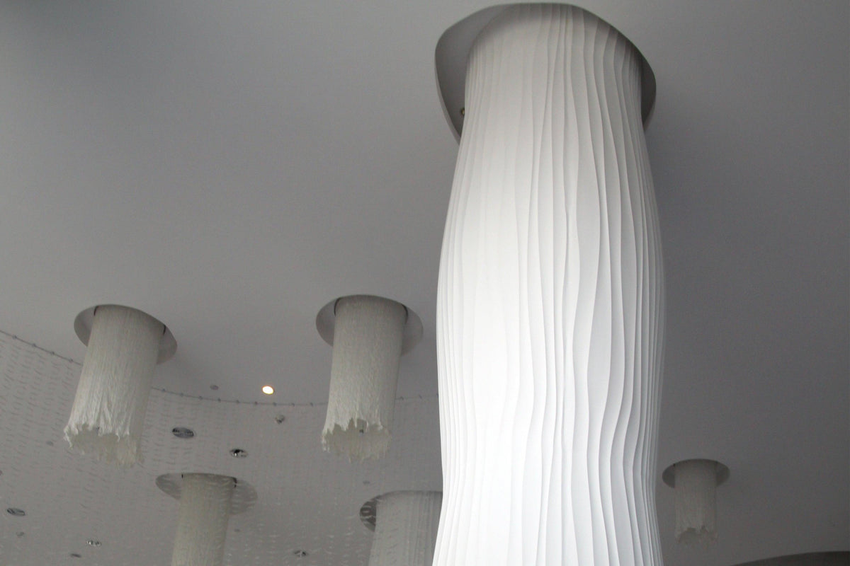 Side view of white solid surface decorative columns for commercial interiors with seamless acrylic solid surface finish