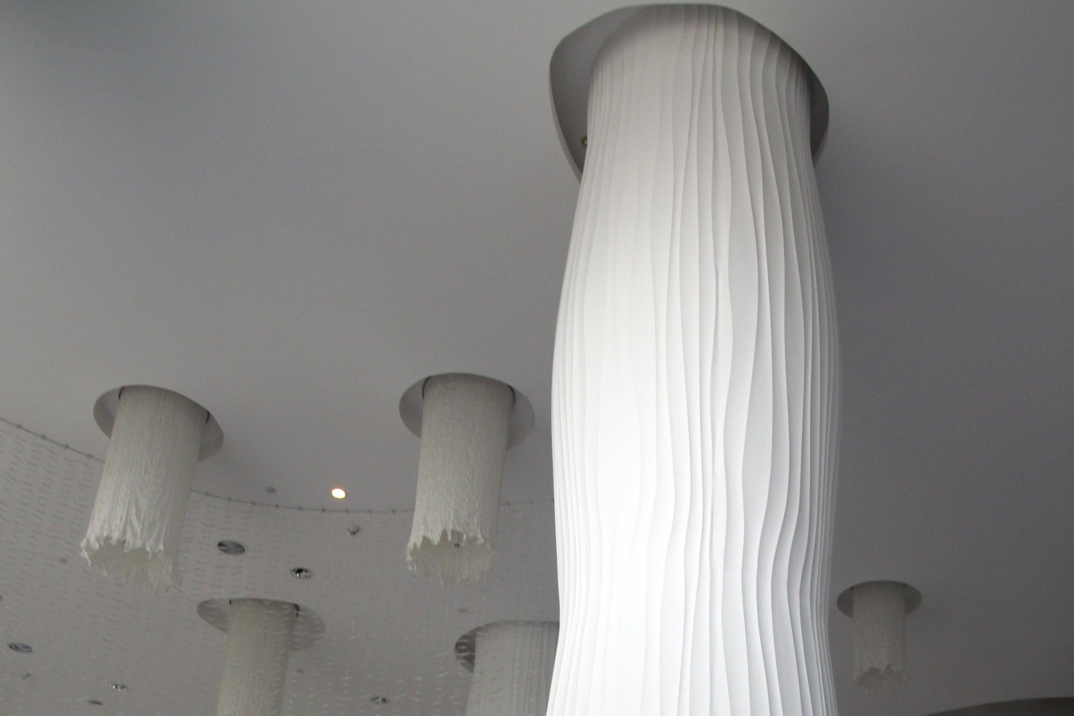 Side view of white solid surface decorative columns for commercial interiors with seamless acrylic solid surface finish