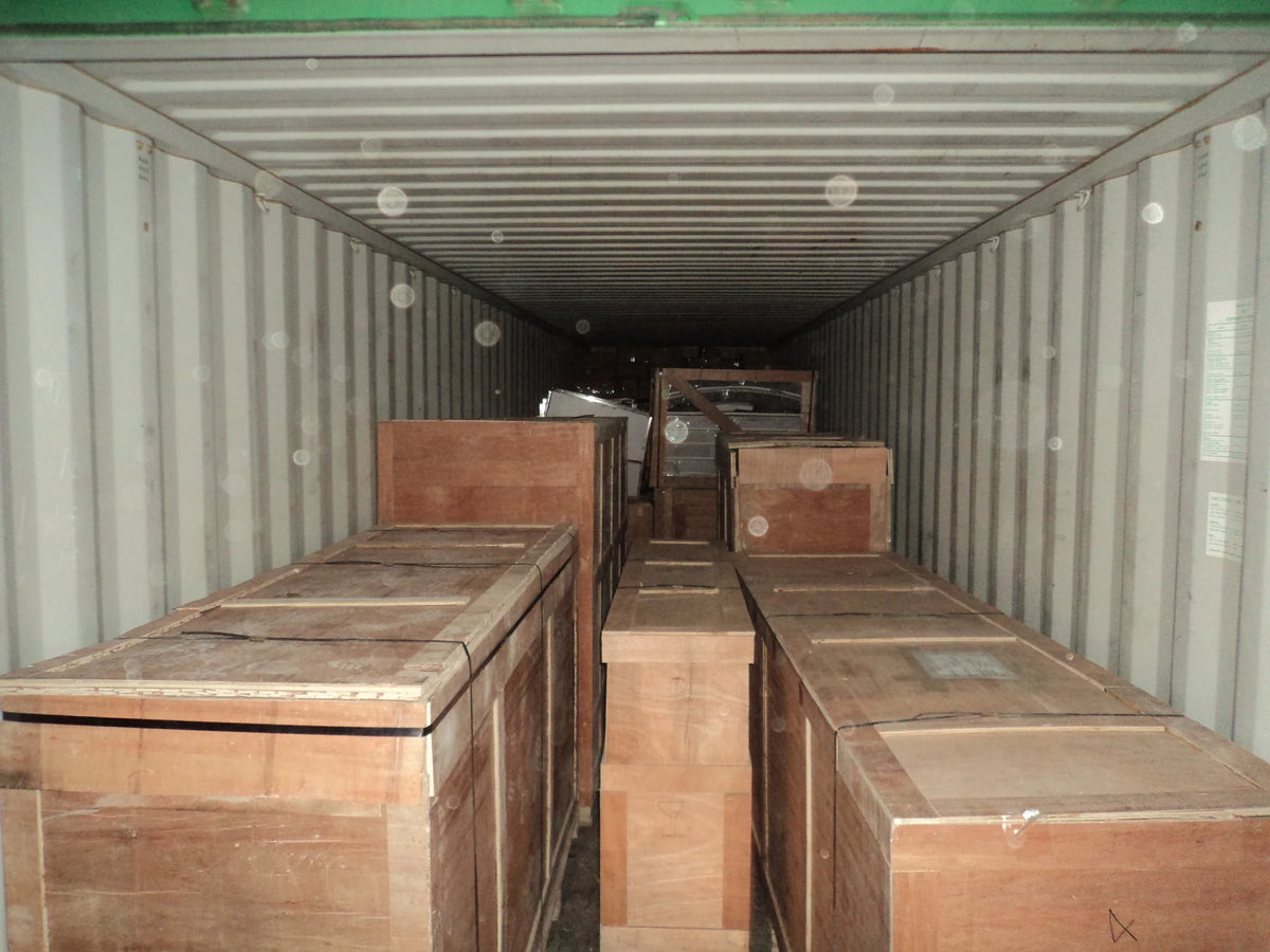 Rows of wooden shipping crates positioned inside a container during loading preparation