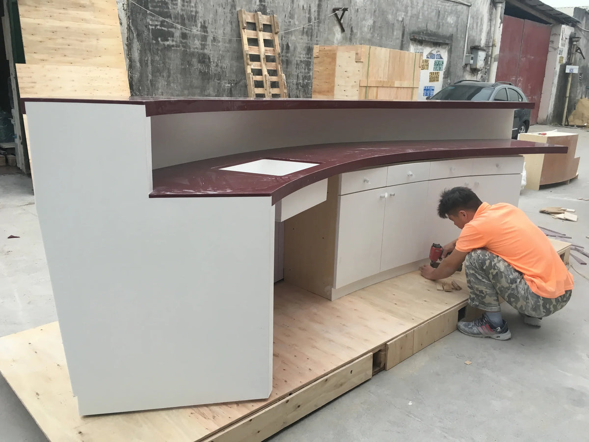 Finished curved reception counter checked on a timber base before protective wrapping