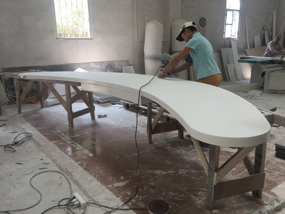 YHS worker finishing a solid surface furniture component